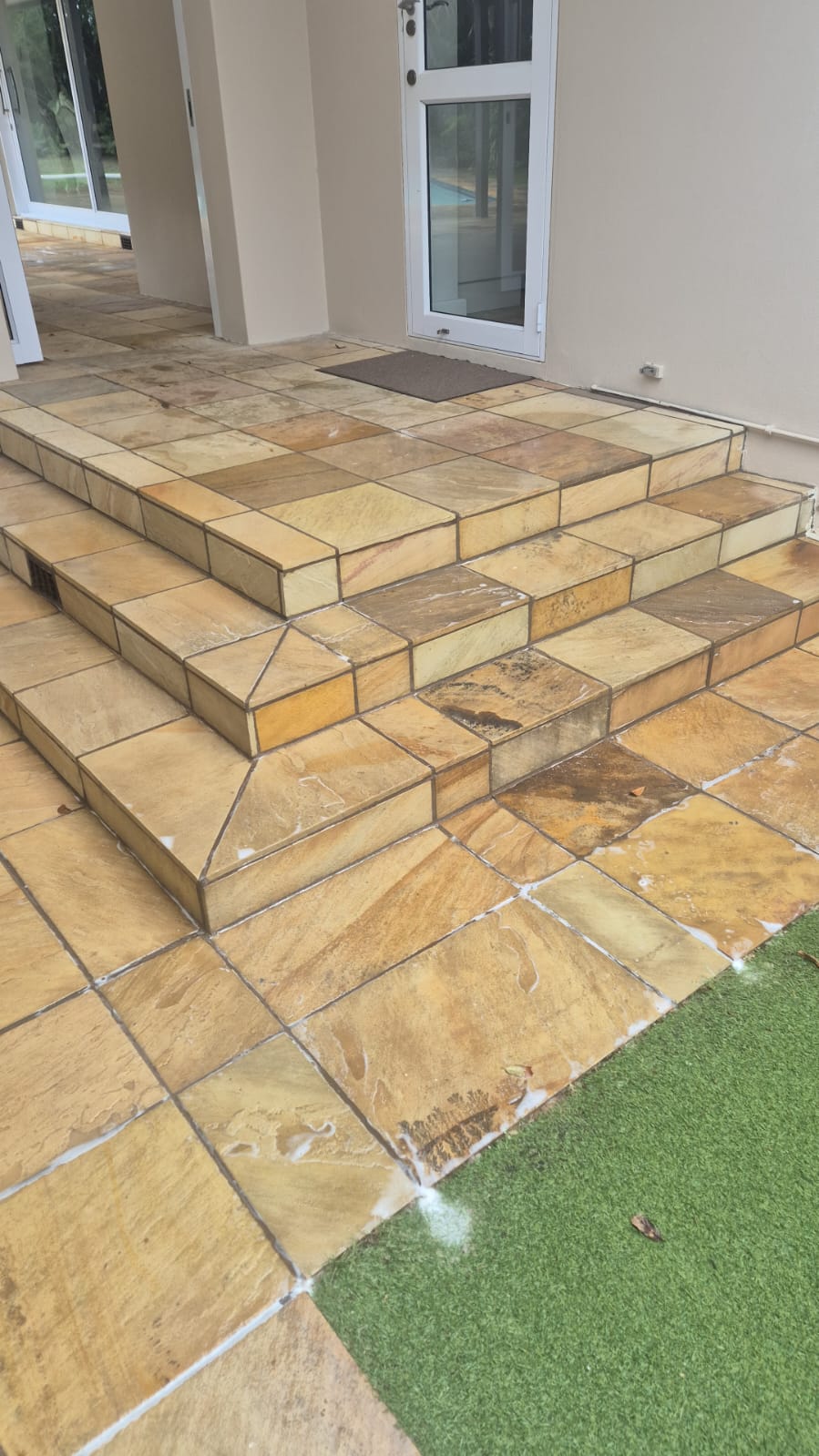 Entrance steps after cleaning — warm sandstone restored