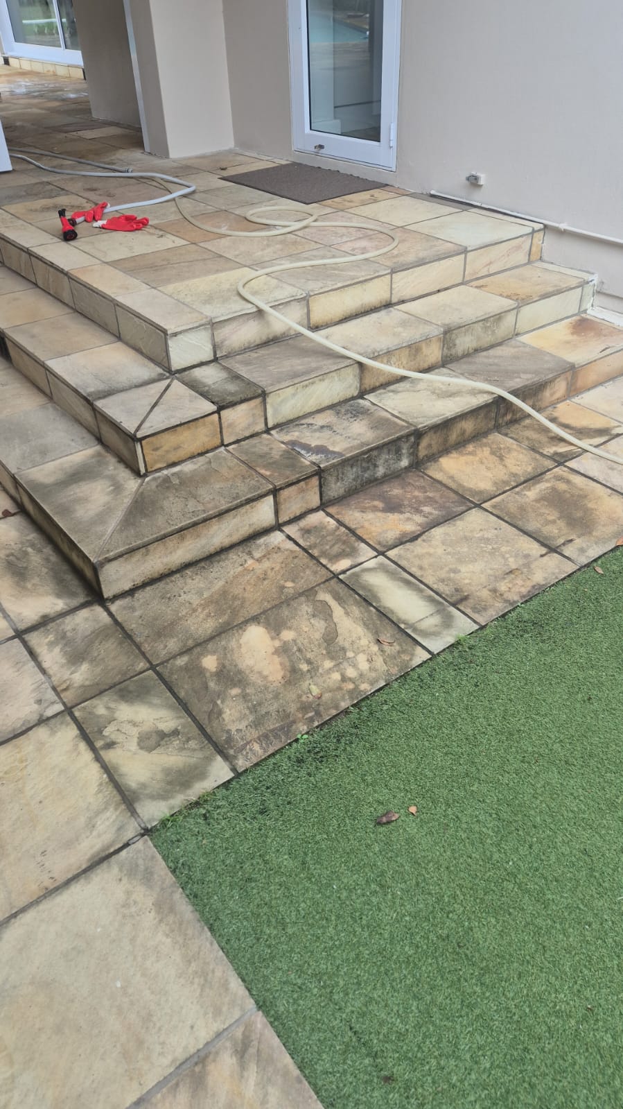 Entrance steps before cleaning — mould staining throughout